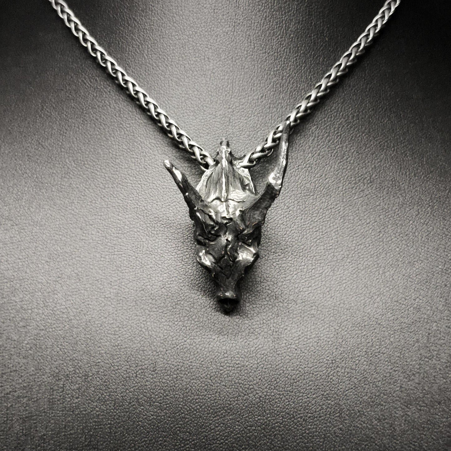 Necklace with a dragon head pendant on a mannequin