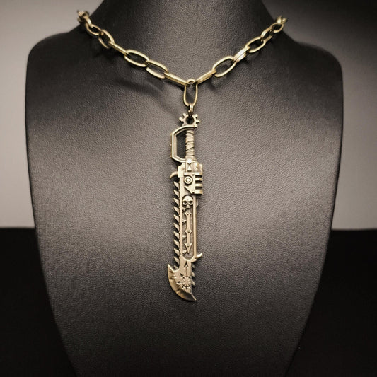 Gold sword-shaped pendant on a black mannequin bust
