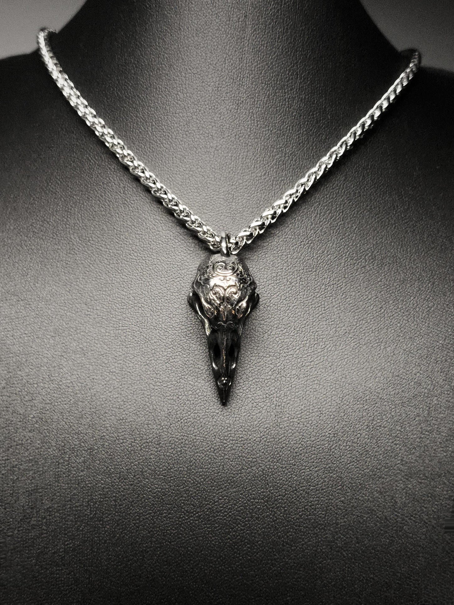 Necklace with a bird skull pendant on a mannequin